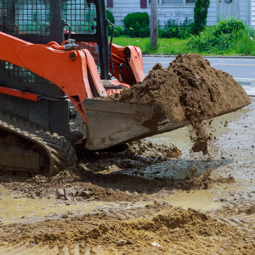 Excavation services in collin county texas, using a skid steer loader to move dirt on a construction site. Equipment used in Excavation and Site Services in Northeast Texas