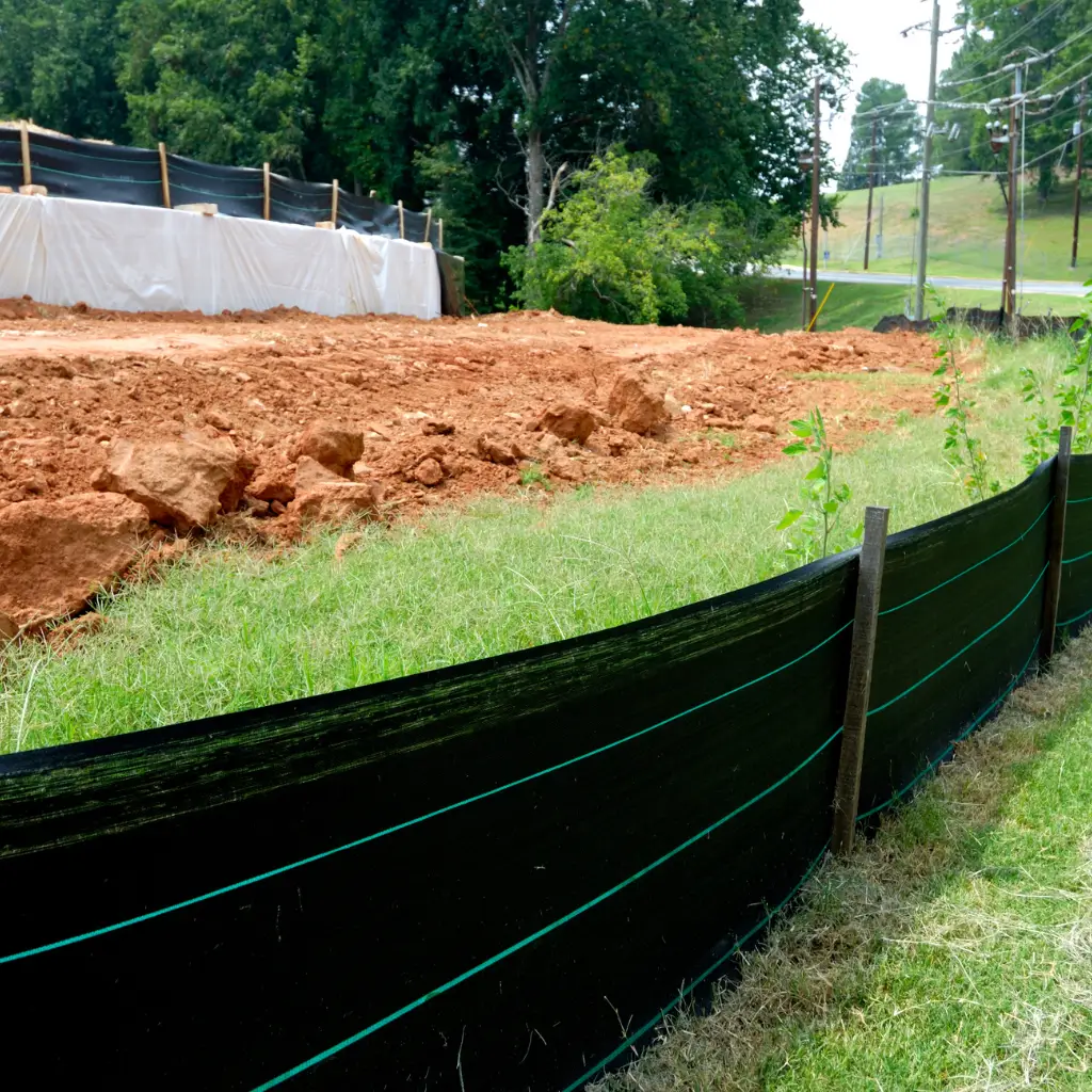 Erosion control and silt fence installation at a construction site – Outta Bounds Excavation prioritizing environmental safety and compliance with land development regulations.