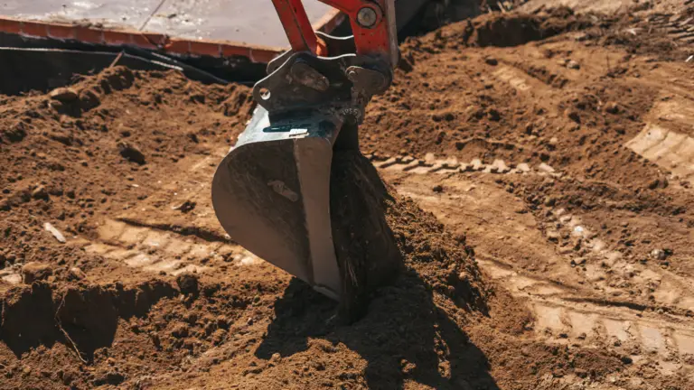 Custom Excavation and Site Services in the DFW Metroplex using a Shovel in dirt representing excavation services focused on quality and hard work in Texas.