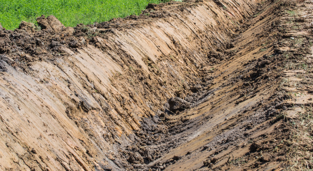 Excavator has cut a Drainage Ditch Construction in Northeast Texas