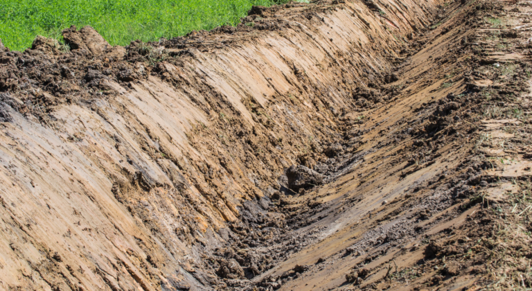 Excavator has cut a Drainage Ditch Construction in Northeast Texas