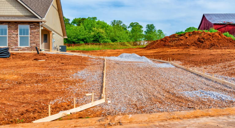 Gravel driveway installation in Northeast Texas with compacted base and clean edges as a part of Driveway and Drainage Services in DFW Metroplex