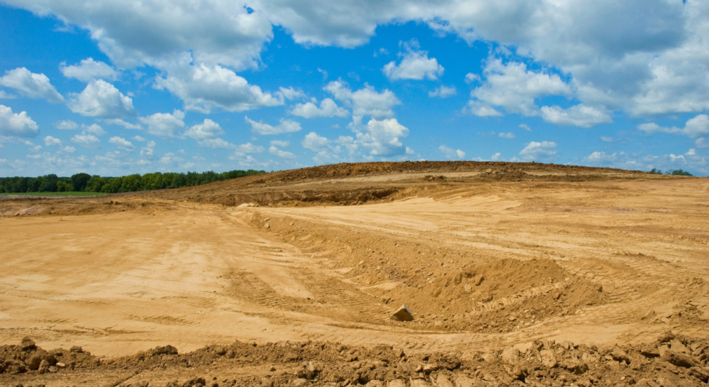 land where an excavator has preformend rough and final grading on a construction site in Northeast Texas