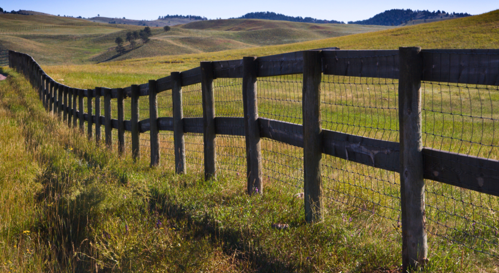 Old wood and wire fence ready for professional fence removal services in Northeast Texas pastureland