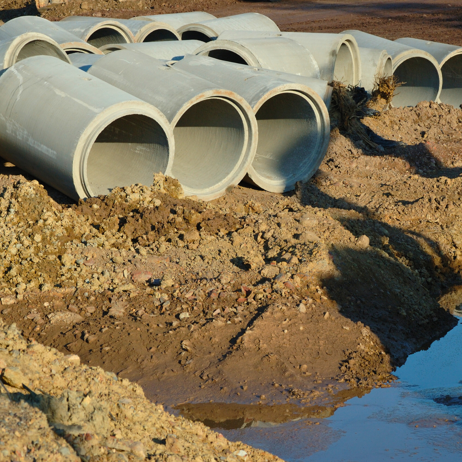 Concrete culvert pipes on site ready for installation – Outta Bounds Excavation specializing in drainage and culvert solutions for residential and commercial projects.