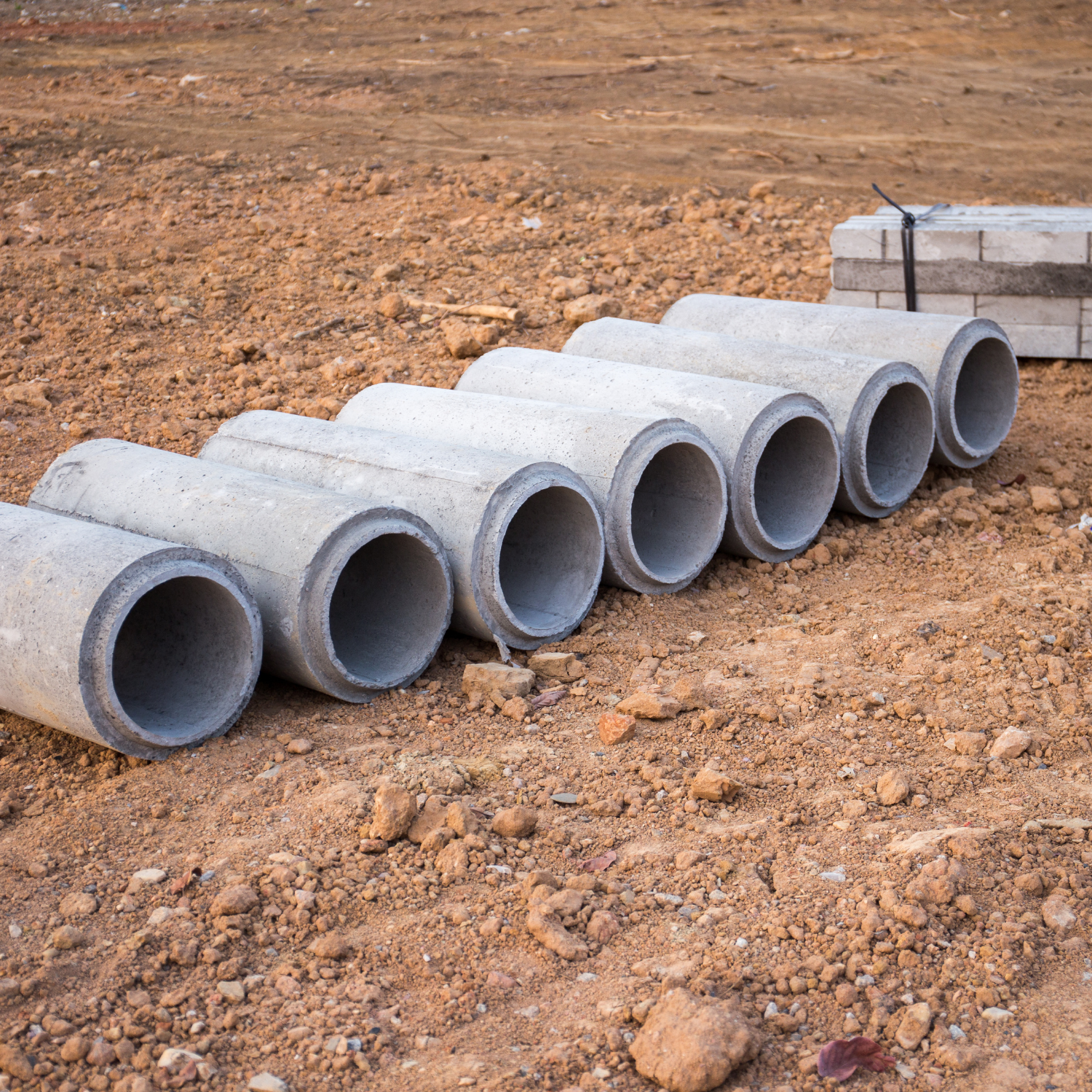 Concrete culvert pipes on site ready for installation – Outta Bounds Excavation specializing in drainage and culvert solutions for residential and commercial projects.