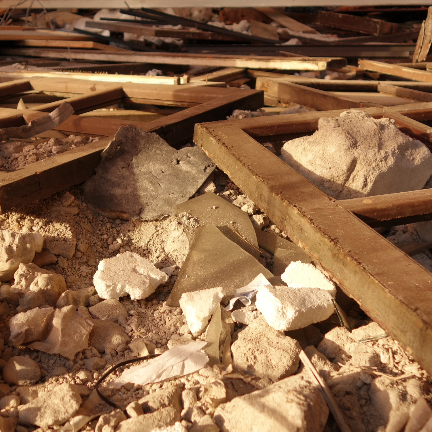 Close-up of structural demolition debris including wood, concrete, and glass – Outta Bounds Excavation ensuring safe teardown and debris removal for residential and commercial projects.
